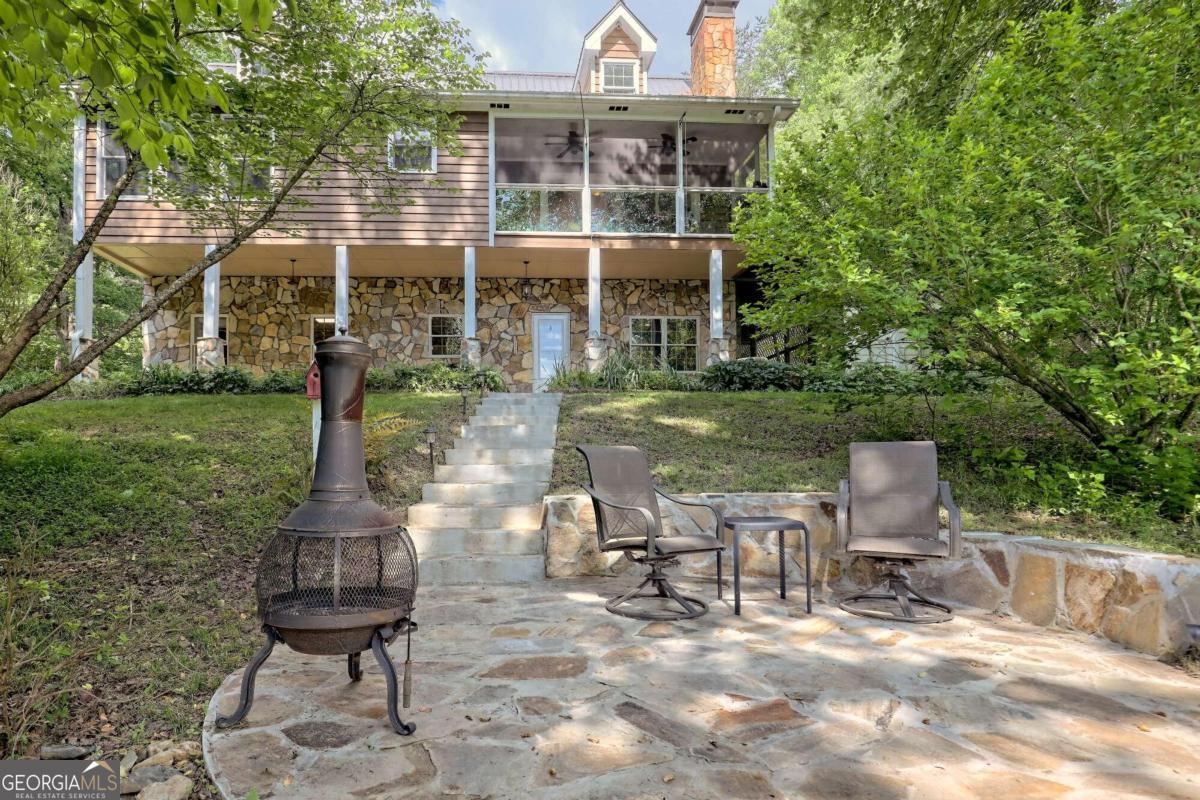 a front view of a house with a yard table and chairs