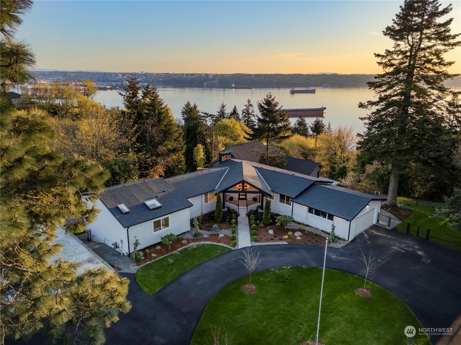 an aerial view of a house with a garden and lake view