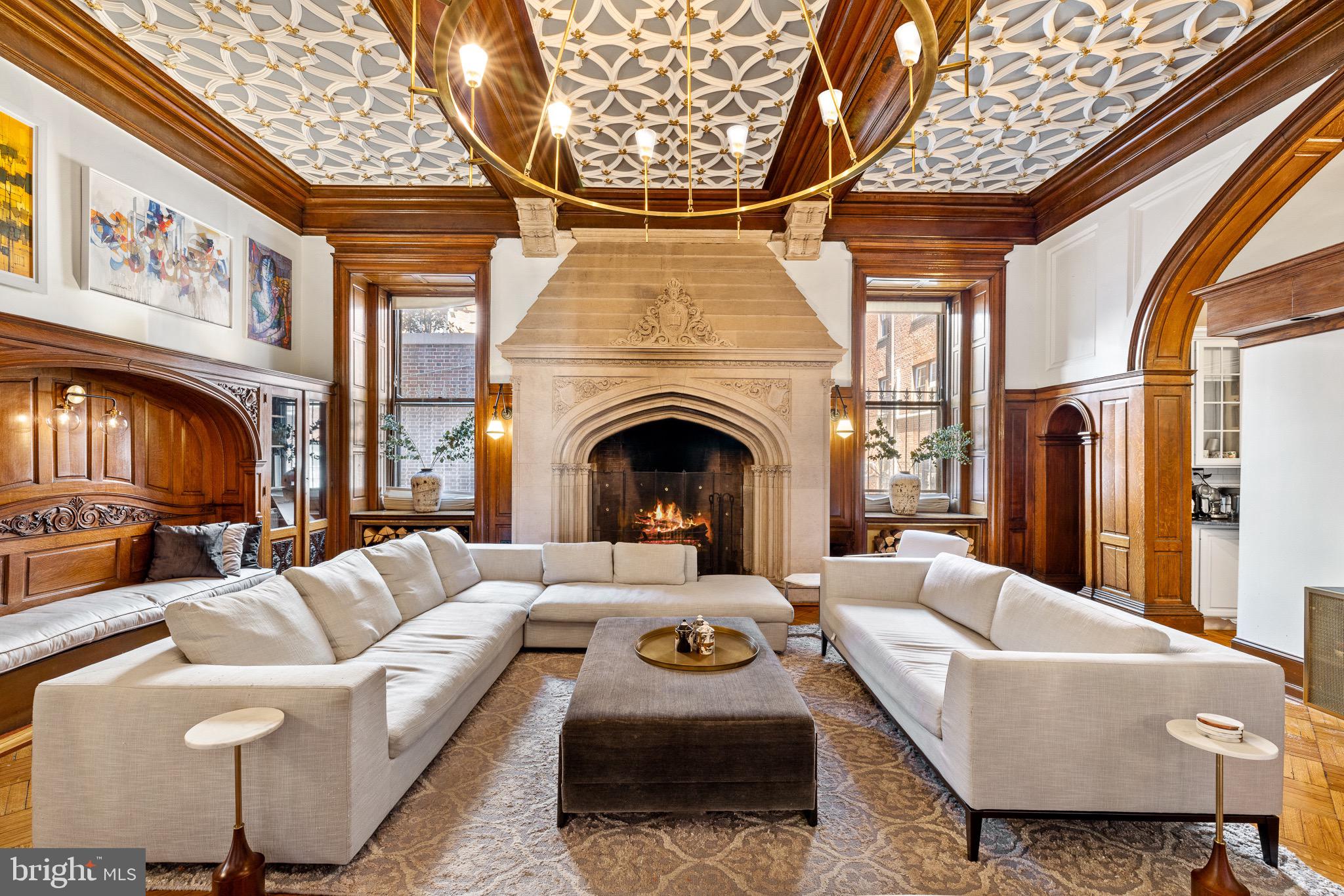 a living room with furniture a fireplace and a large window