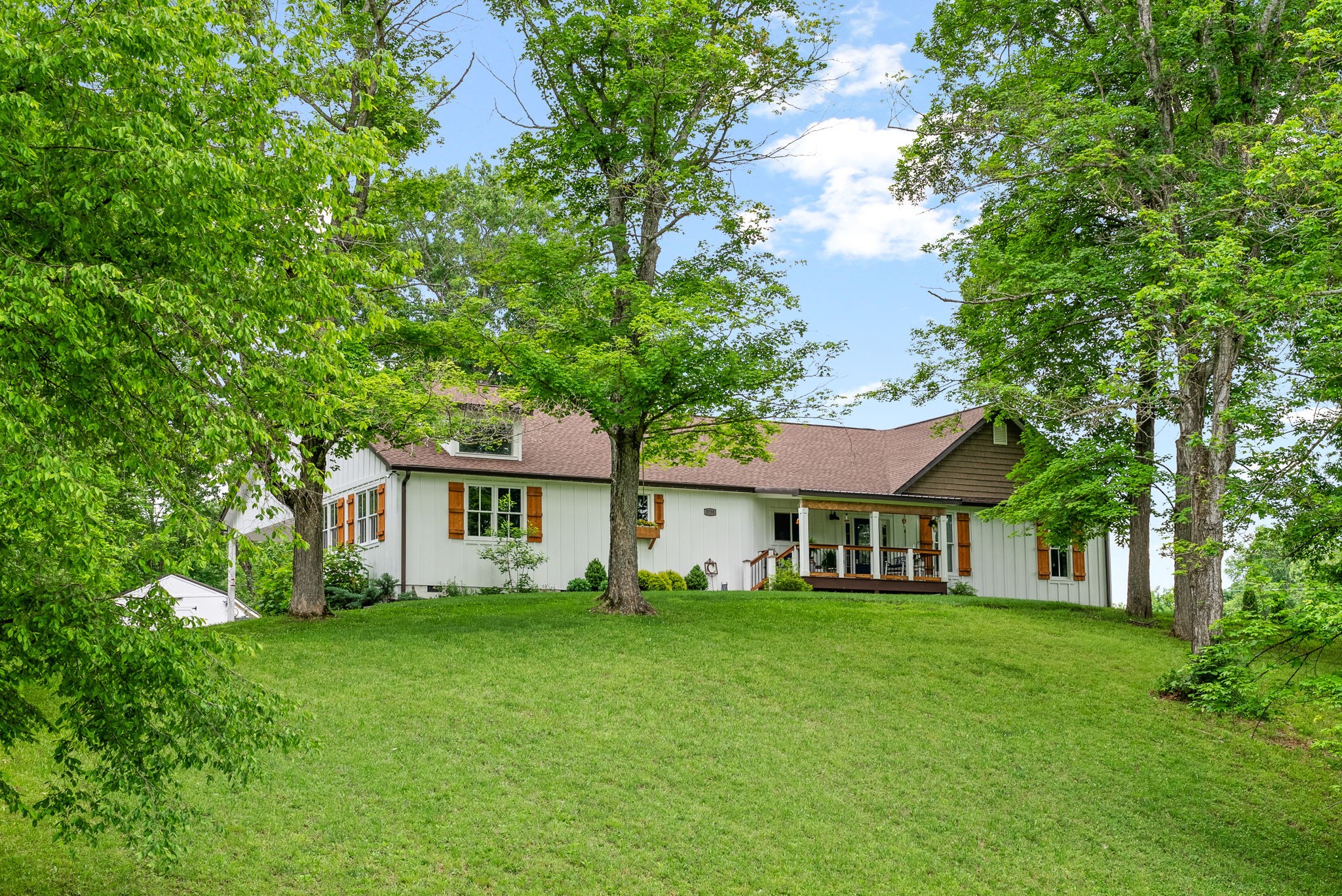 a front view of house with yard and green space