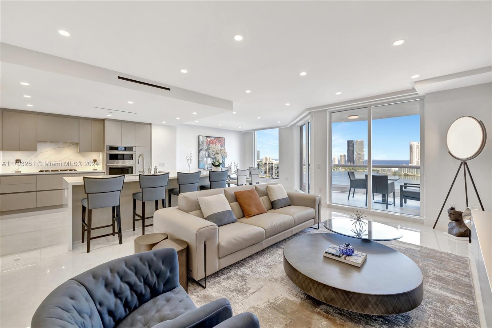 a living room with furniture kitchen and a table