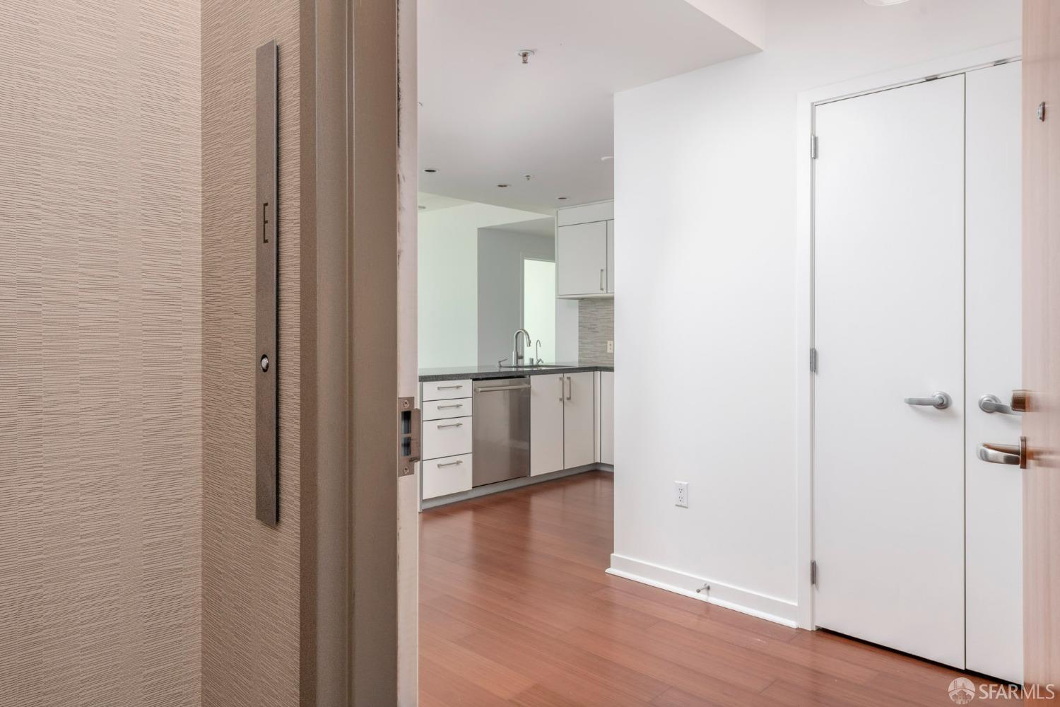 a view of a hallway with wooden floor