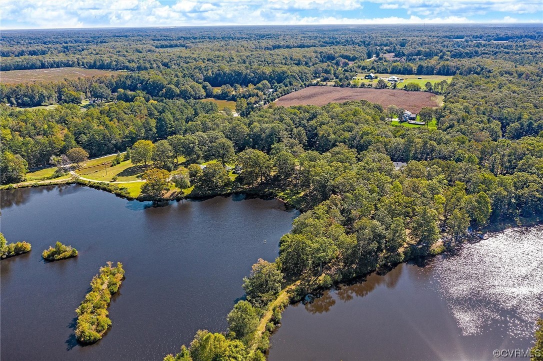 an aerial view of lake and residential houses with outdoor space