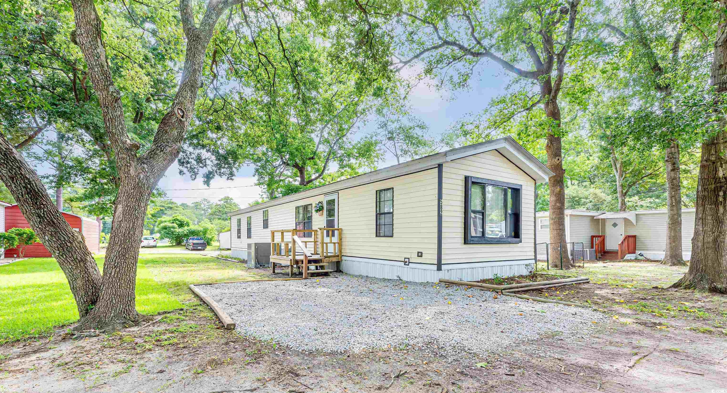 View of side of property with a yard