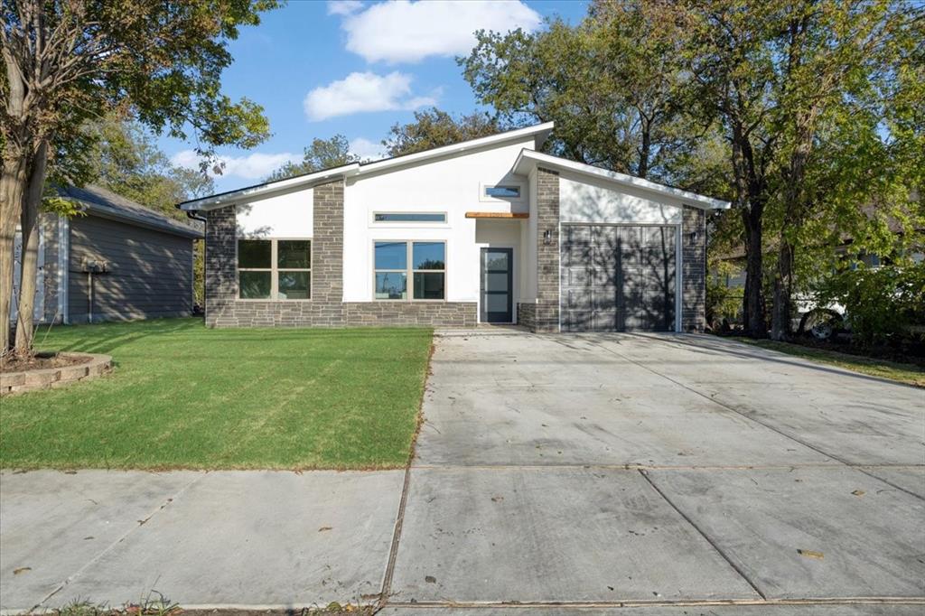 a front view of house with yard and green space