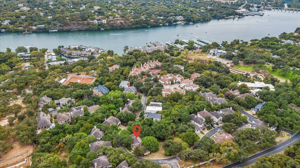 an aerial view of a houses with outdoor space and lake view