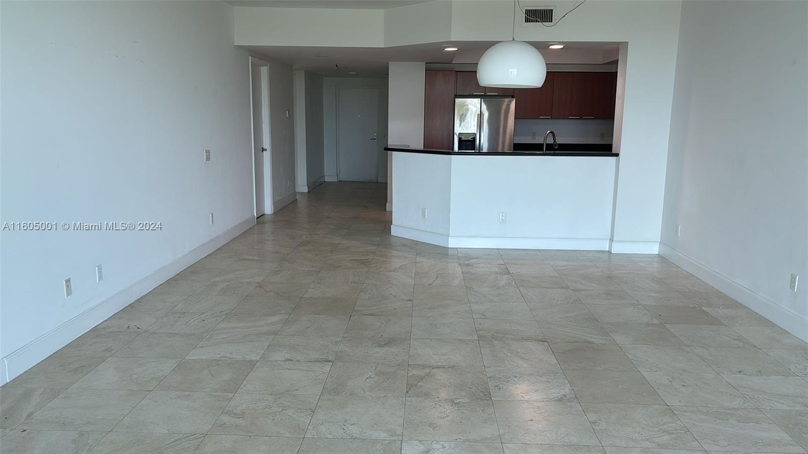 a view of a kitchen counter space and hallway