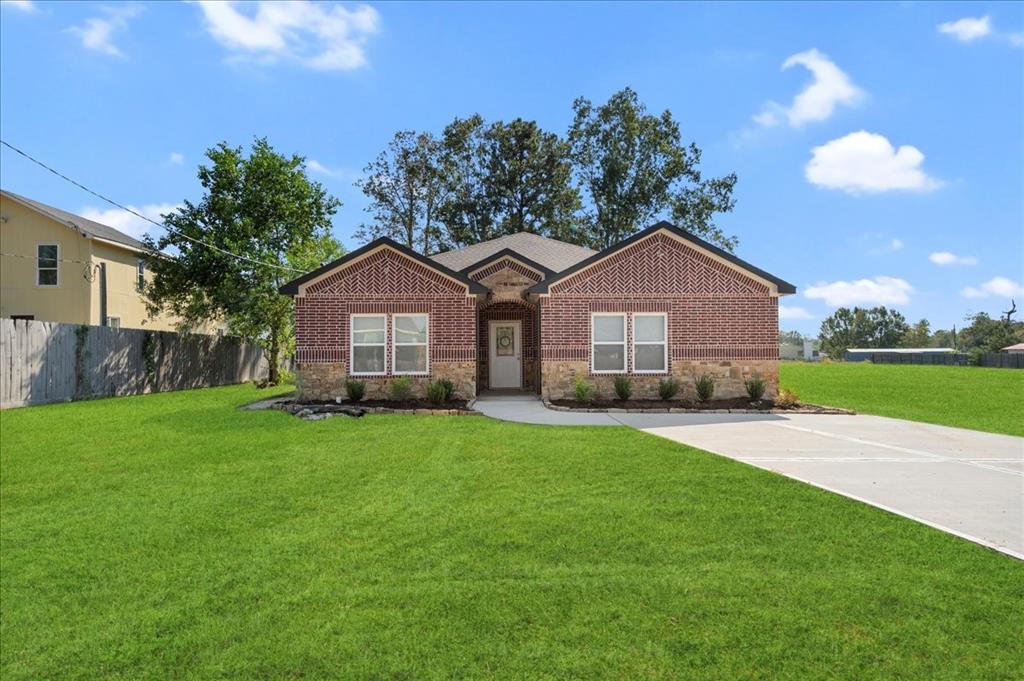 a front view of a house with yard and green space