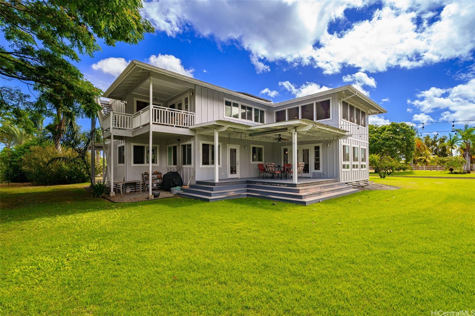 a view of a house with a swimming pool and a yard