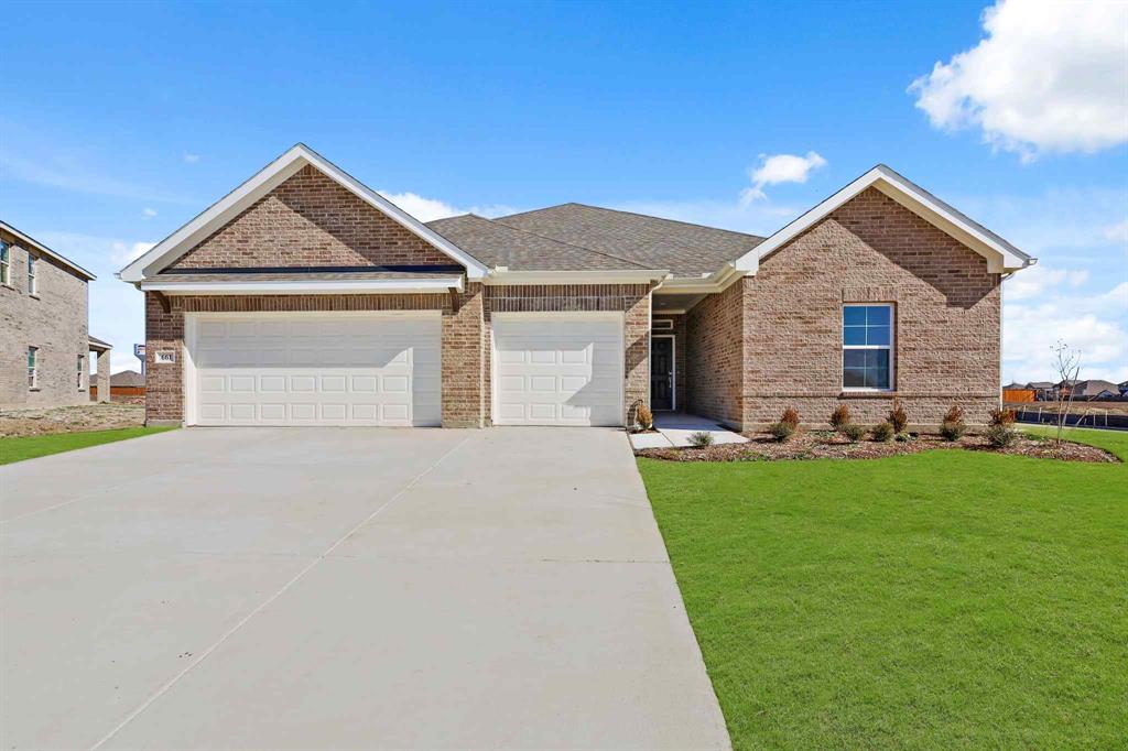 a front view of house with yard and green space