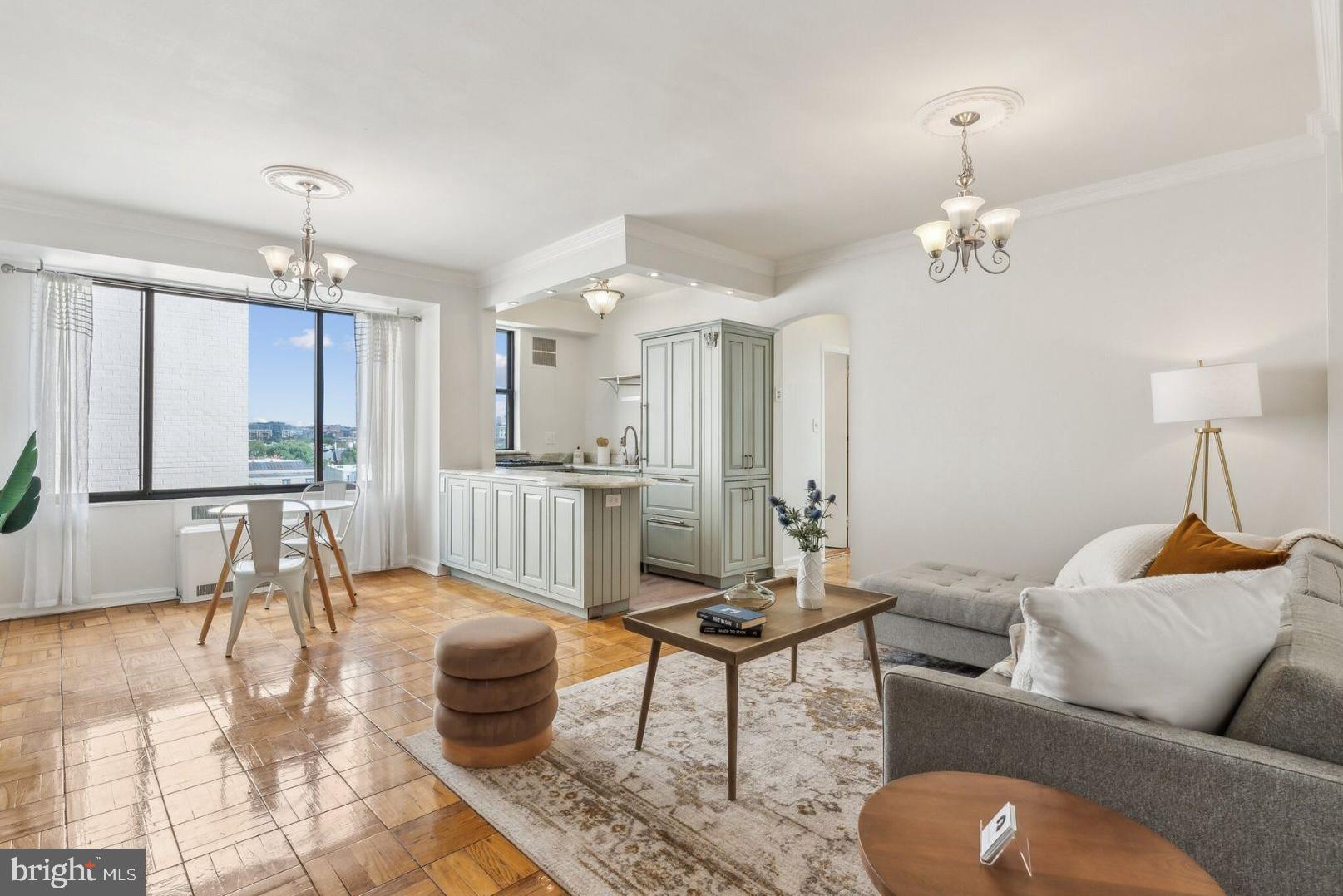 a living room with furniture and a chandelier