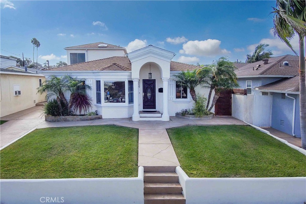 a view of a house with a fountain in a yard