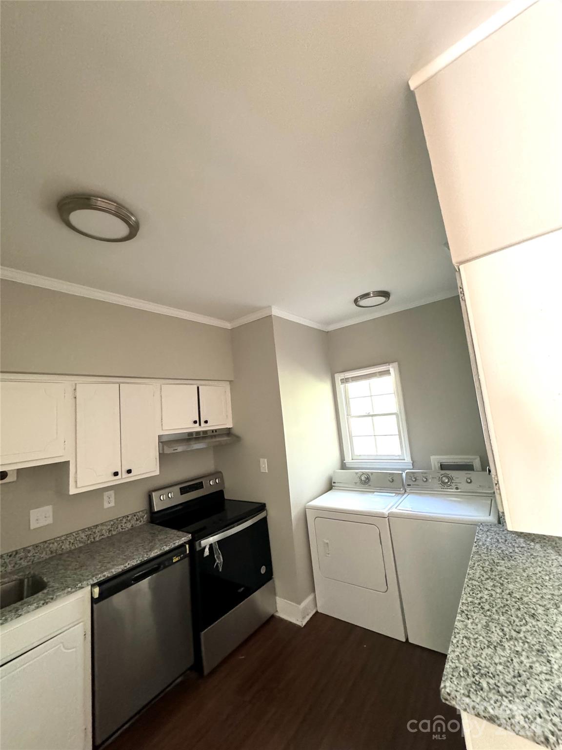 a kitchen with a sink and a stove top oven