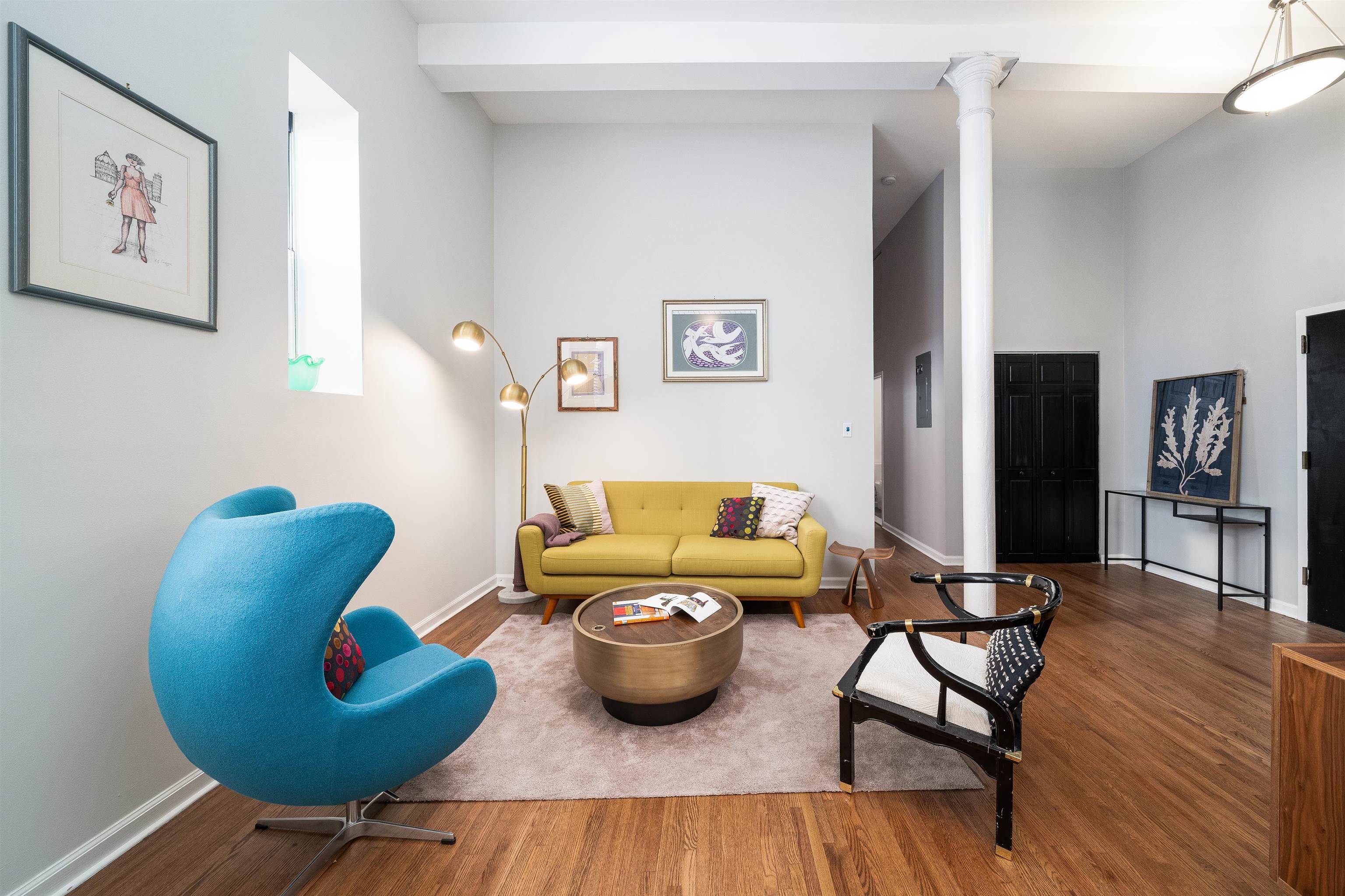 a living room with furniture and wooden floor