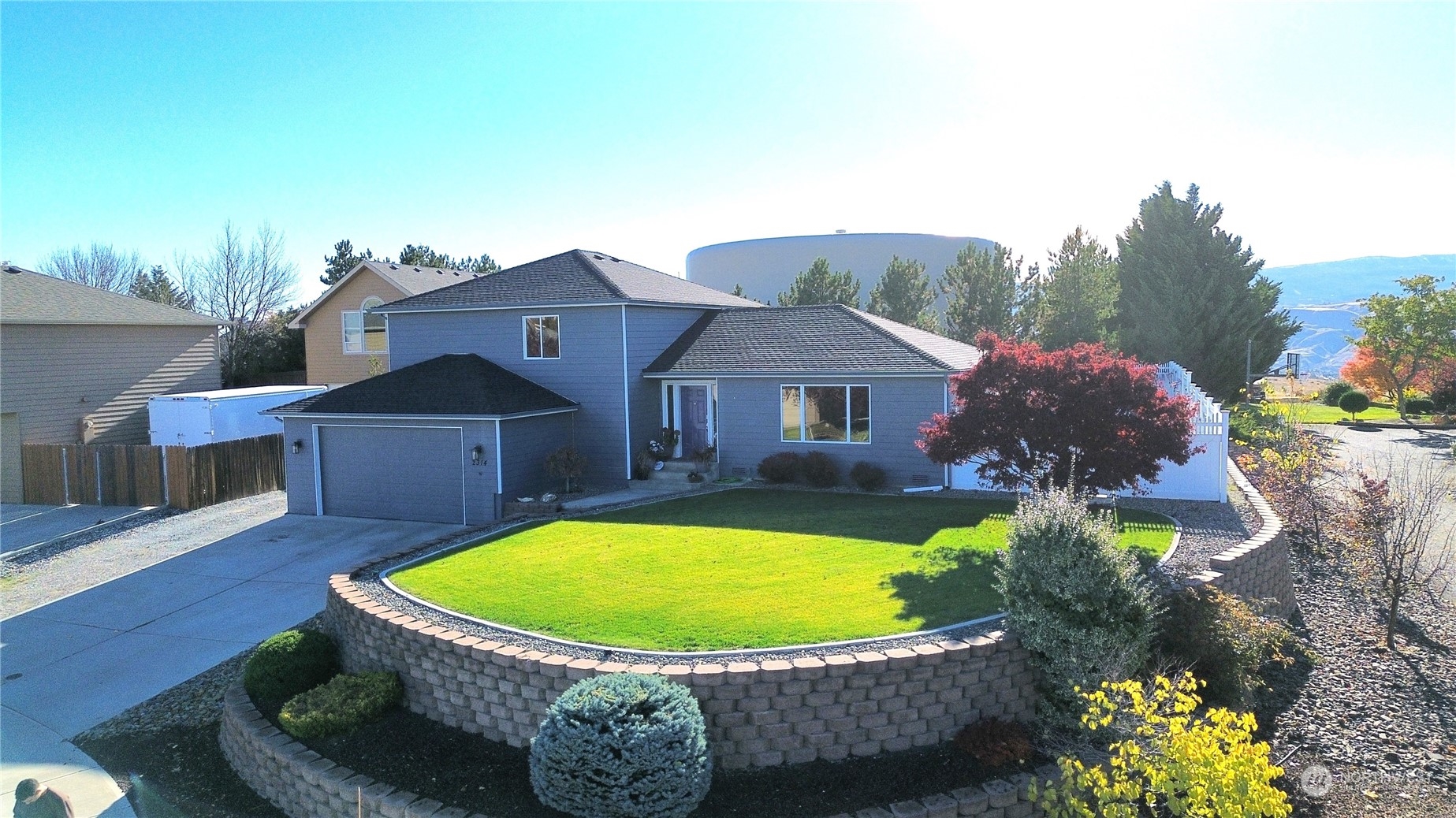 a view of a house with a swimming pool and a yard