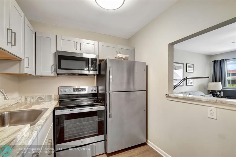 a kitchen with stainless steel appliances a refrigerator stove and microwave