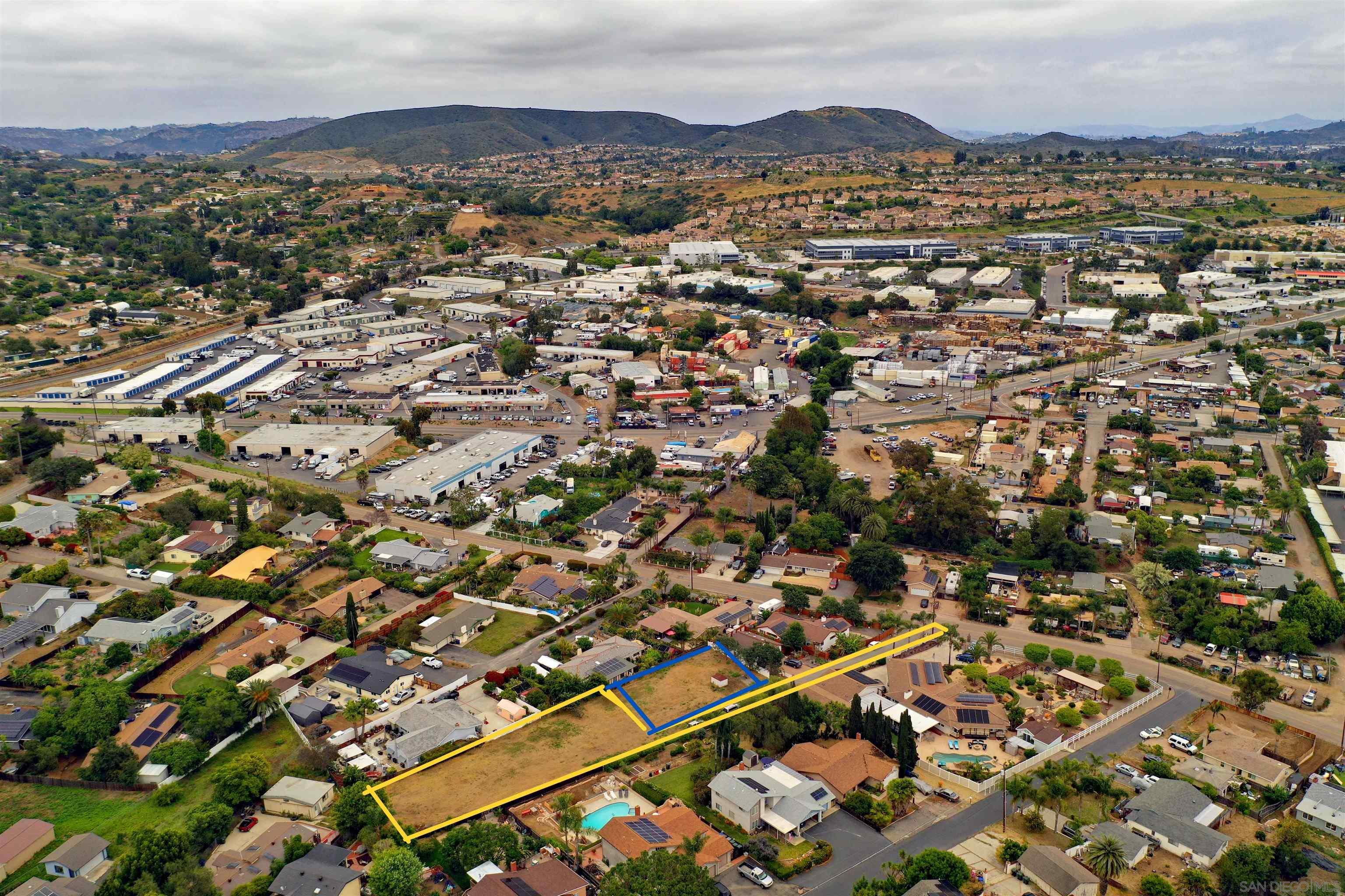 an aerial view of residential houses with city view