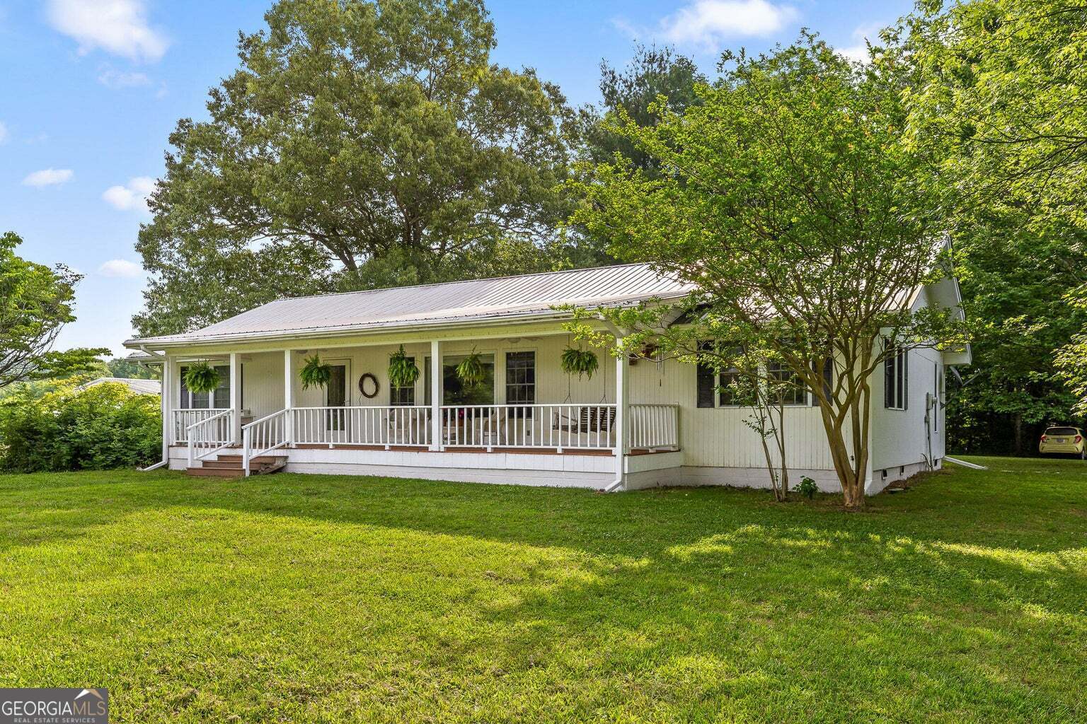 a view of a house with a yard deck and sitting area