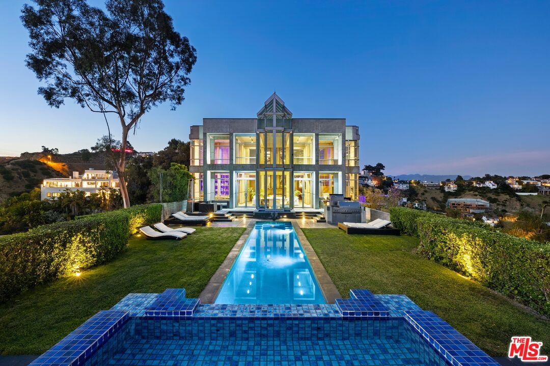 a view of yard with swimming pool and green space