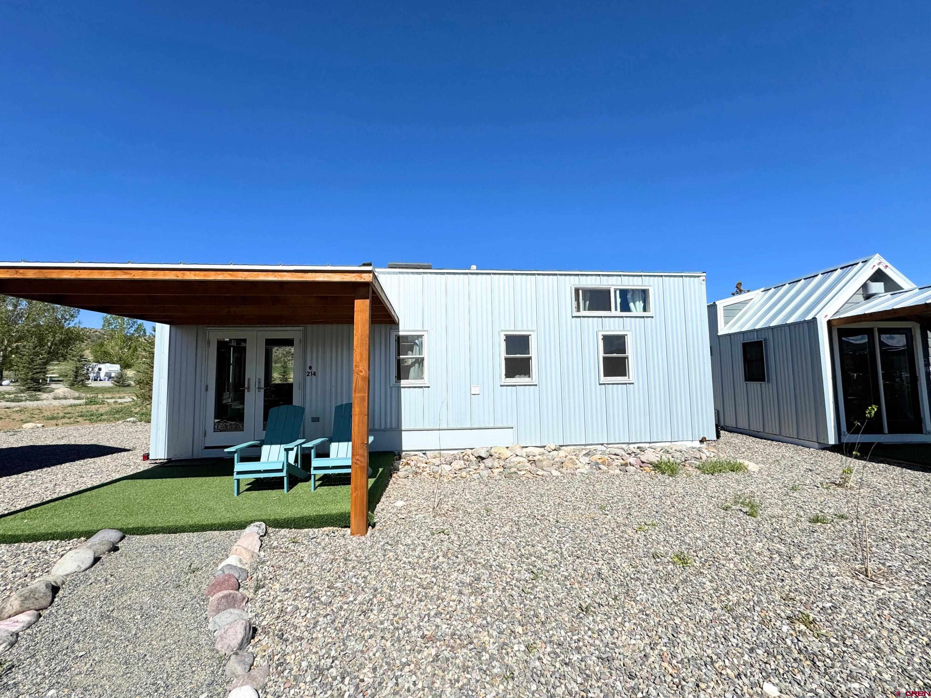 a view of a house with patio and a garden