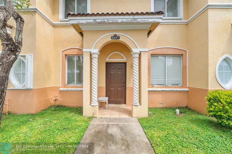 a front view of a house with garden