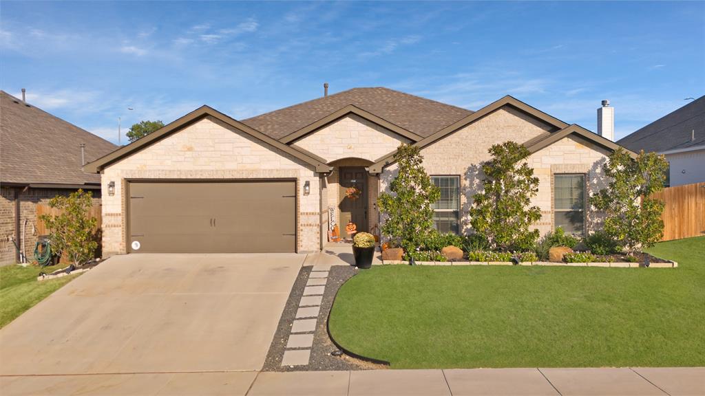 a front view of a house with a yard