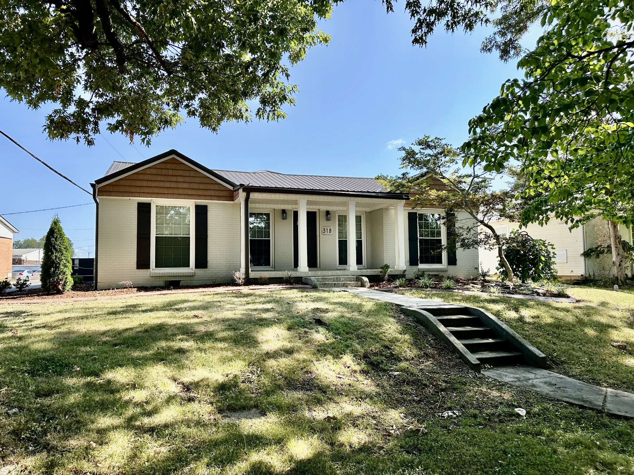 a front view of a house with a garden