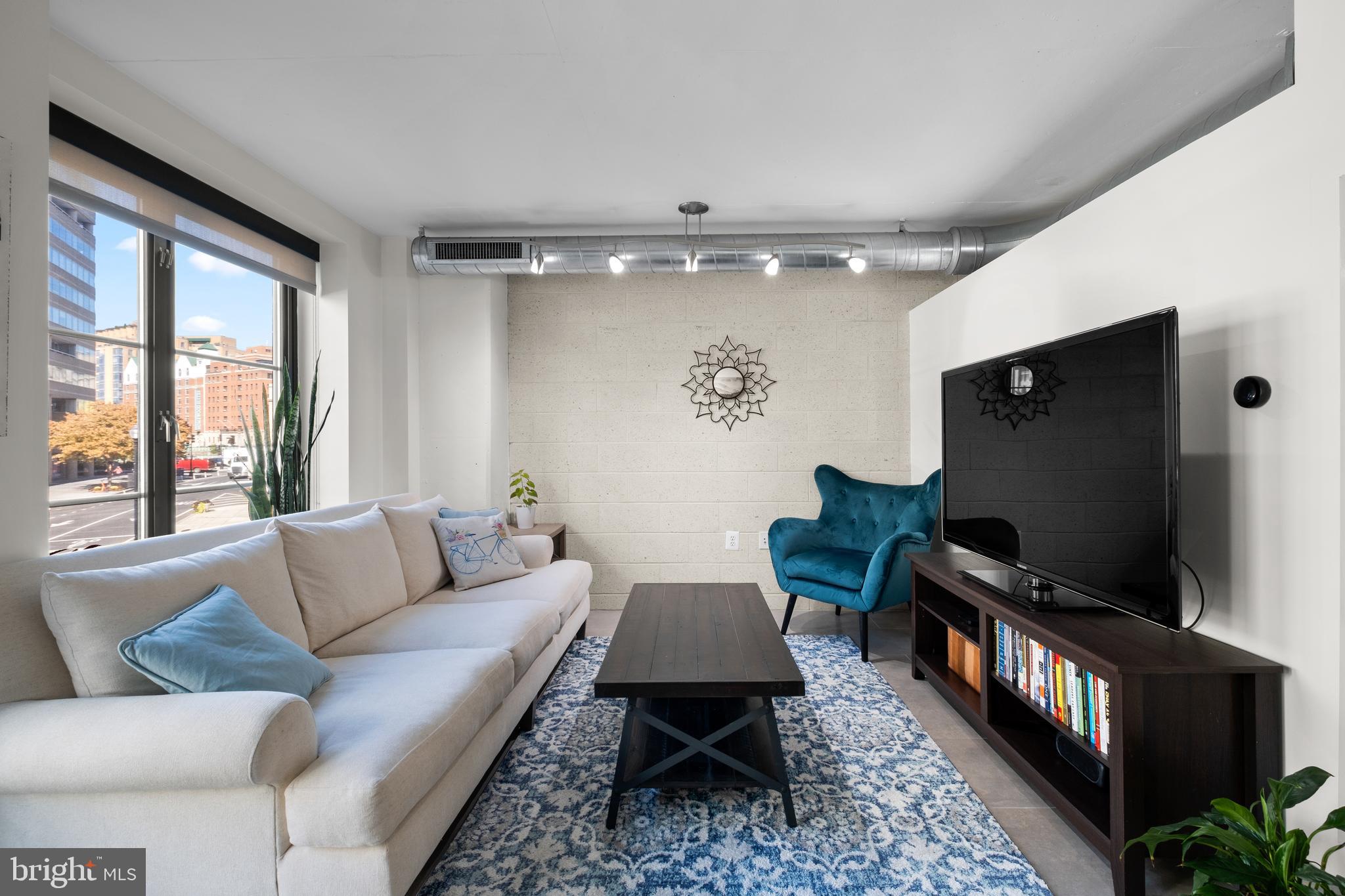 a living room with furniture and a flat screen tv