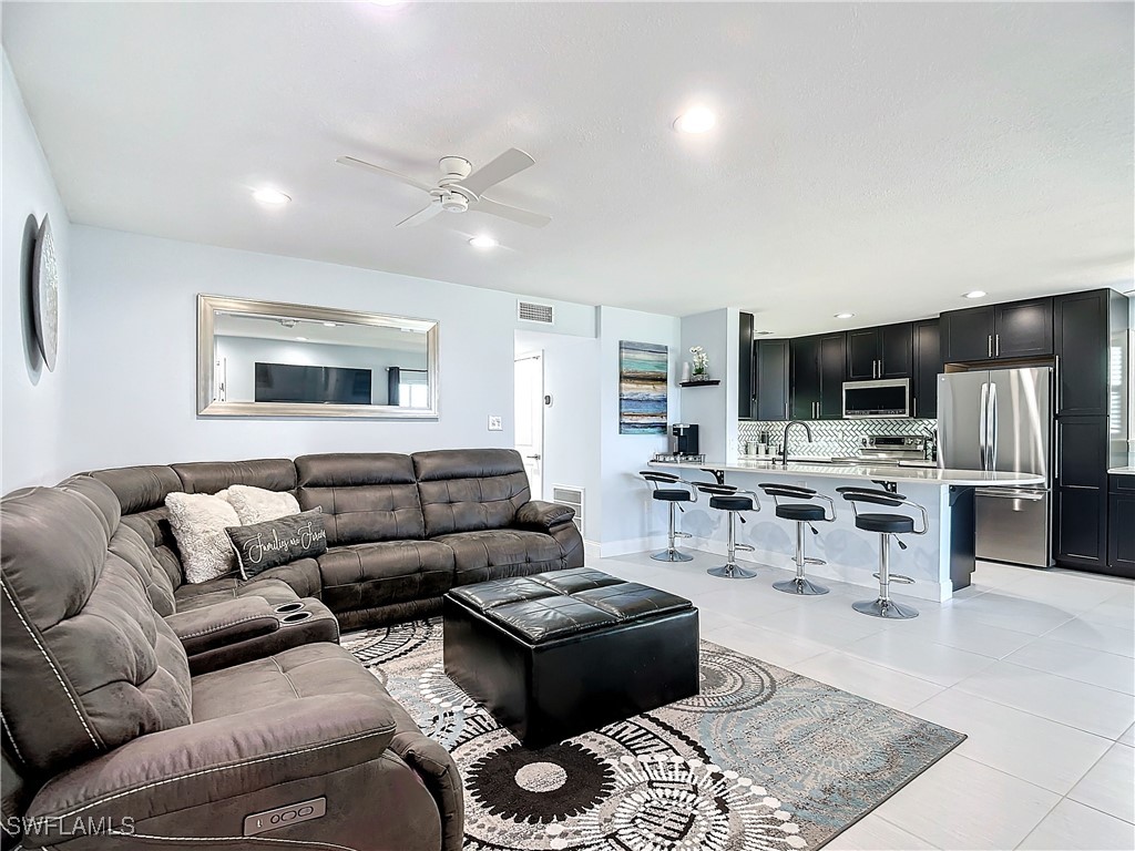 a living room with furniture and kitchen view