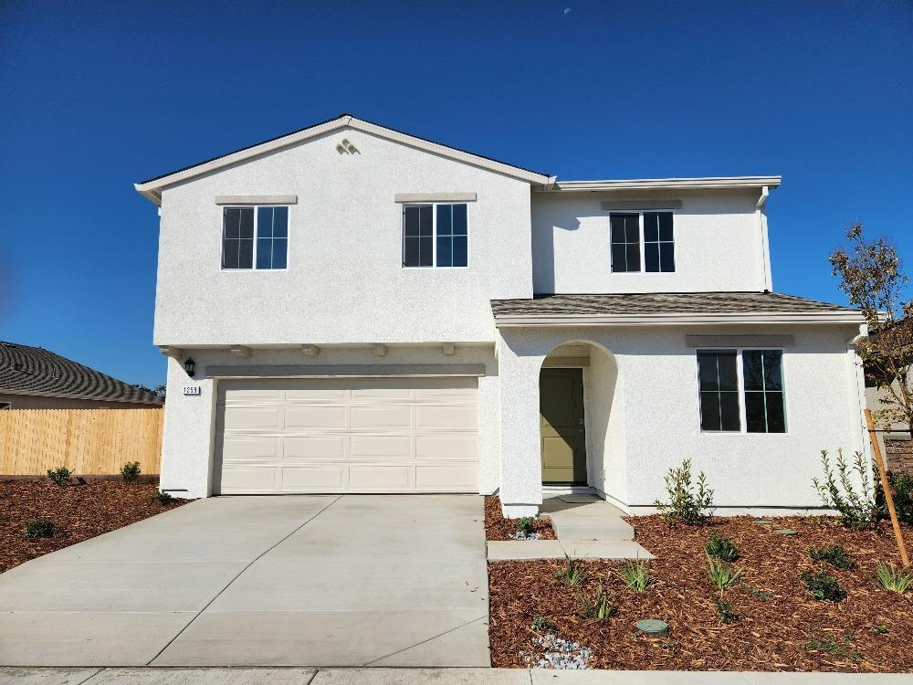 a front view of a house with garage