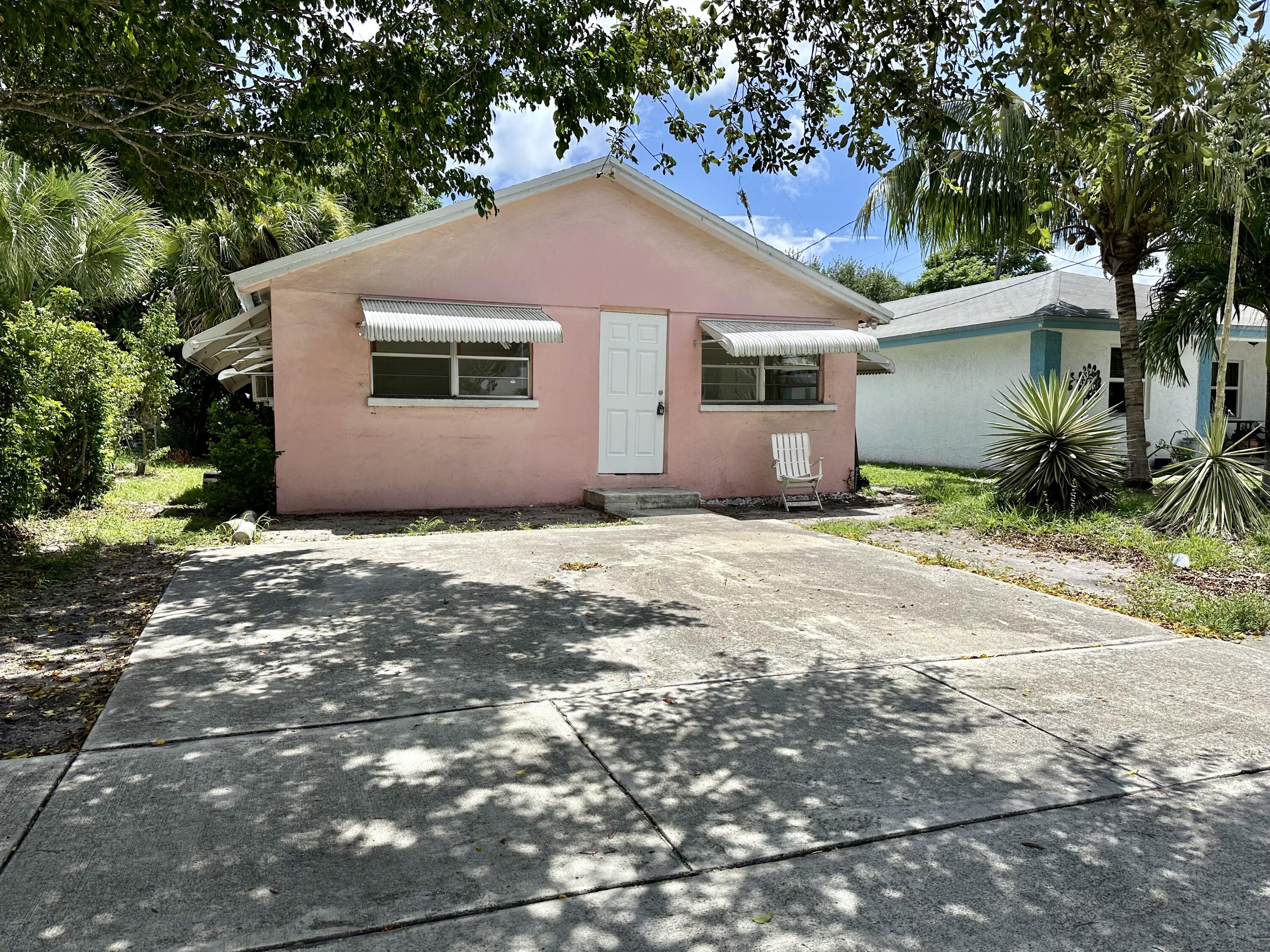 a house that has a tree in front of it