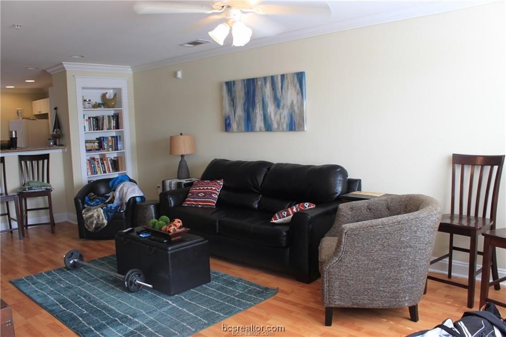 a living room with furniture and wooden floor