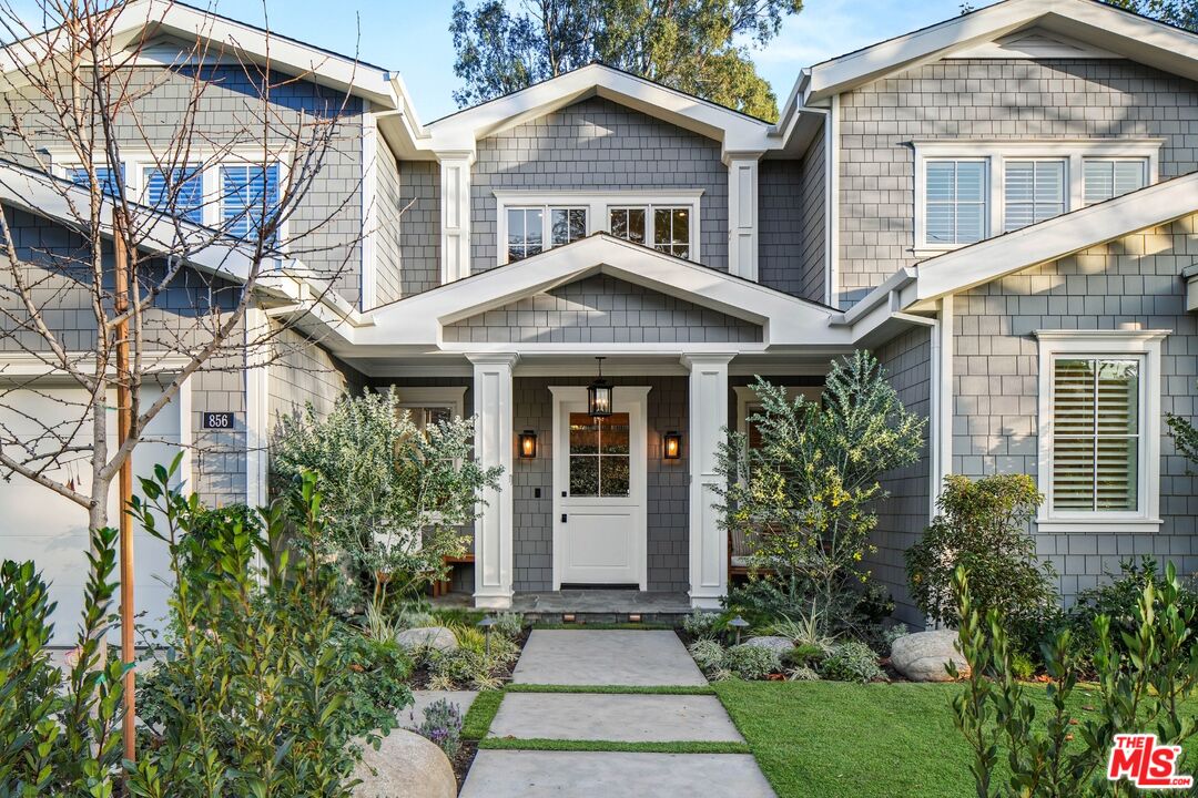 a front view of a house with a garden