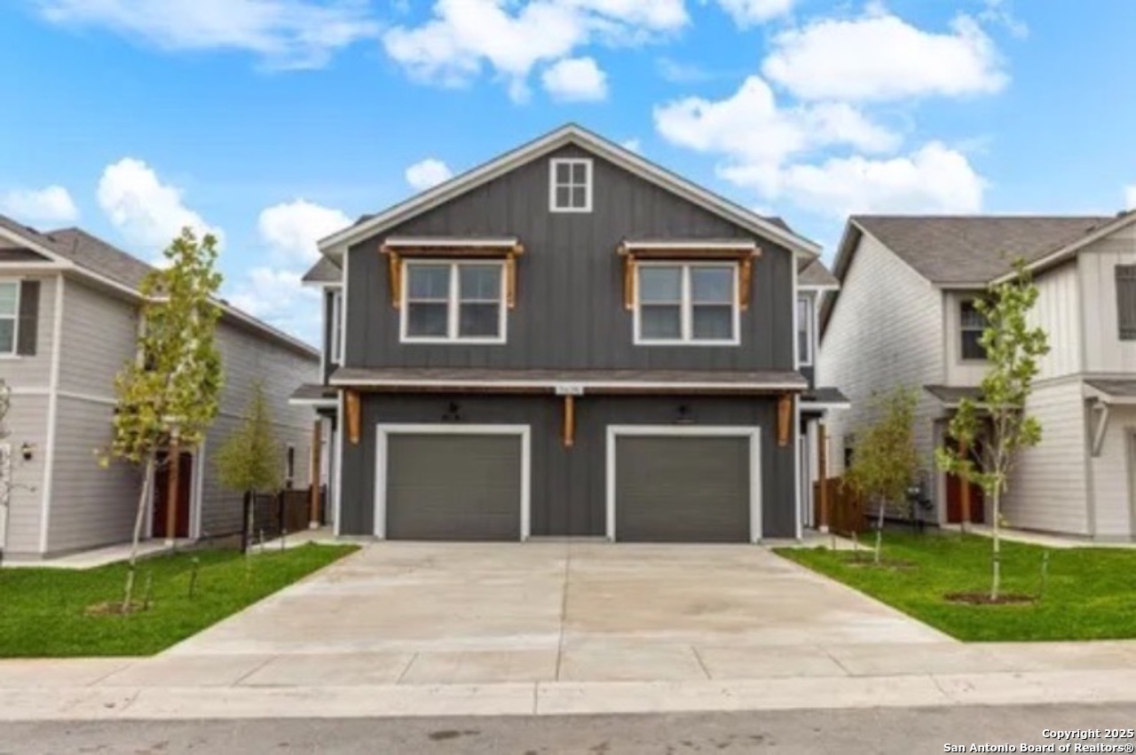 a front view of a house with a yard and garage