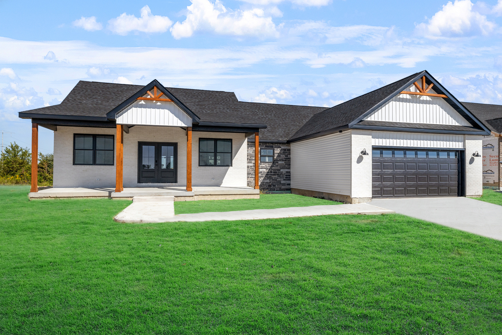 a view of a house with a yard and garage