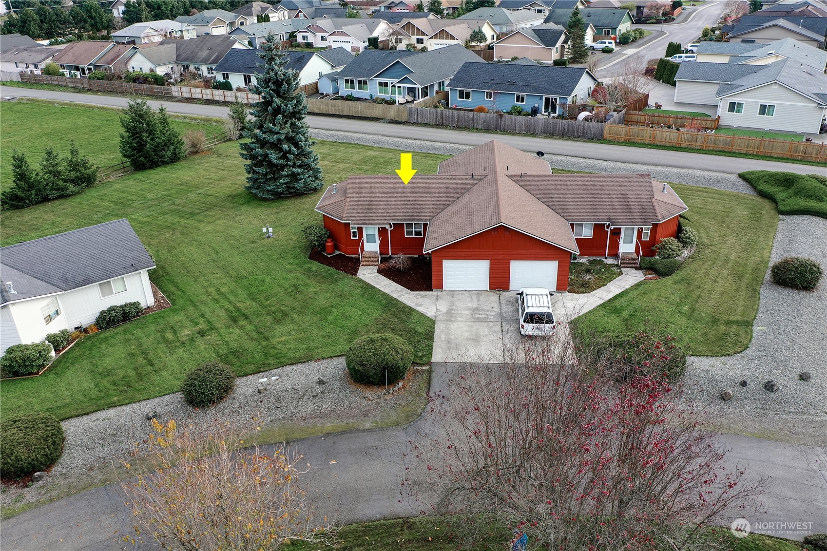 an aerial view of a house with a garden and a yard