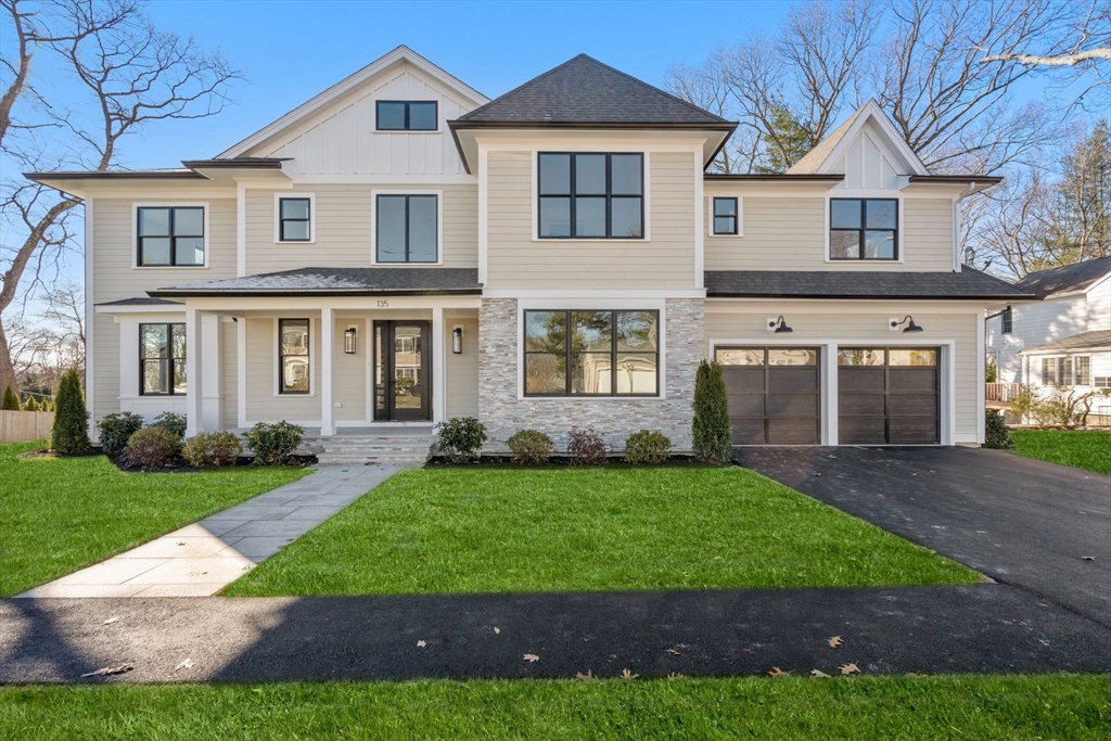 a front view of a house with a yard and garage