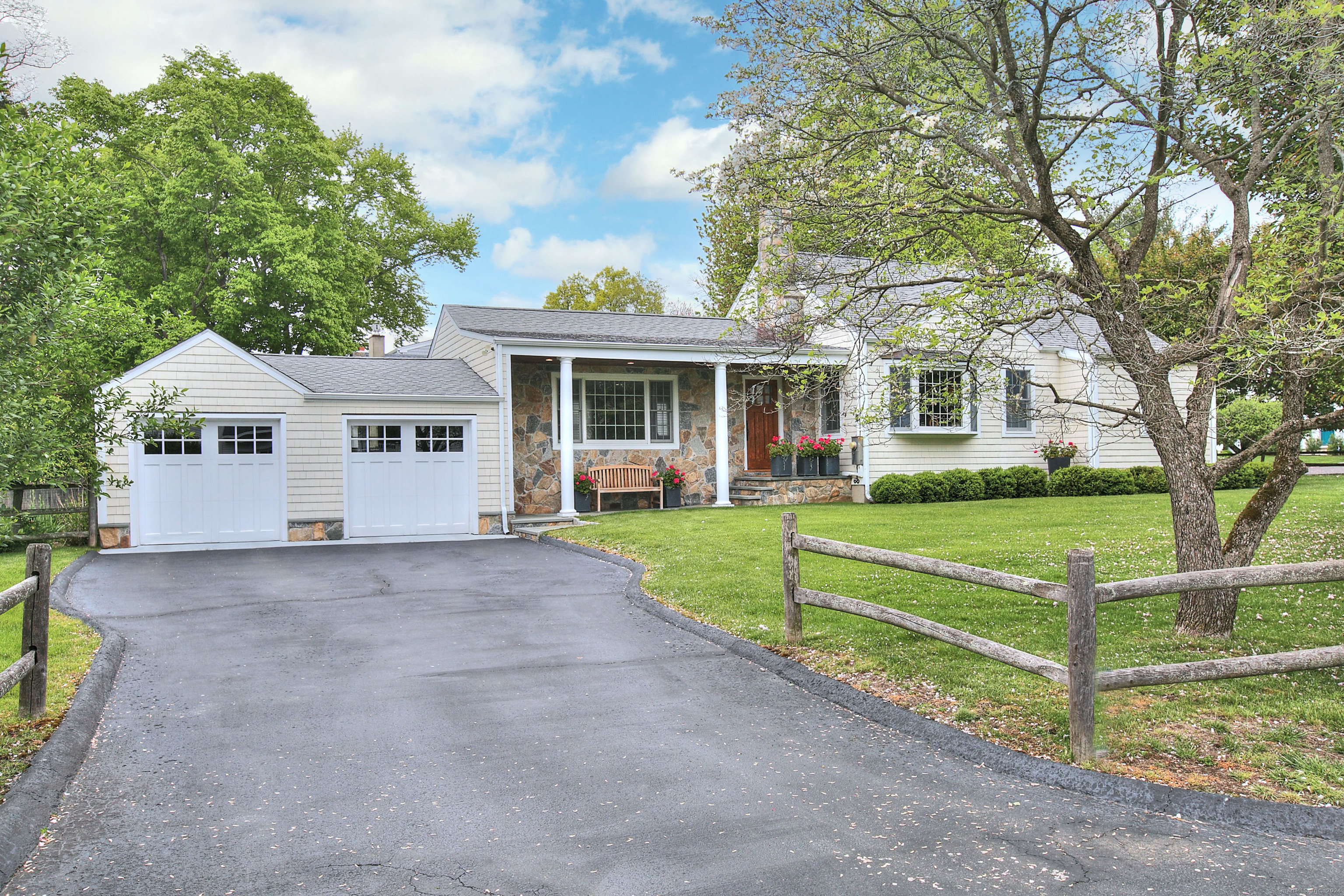 a front view of house with yard and green space