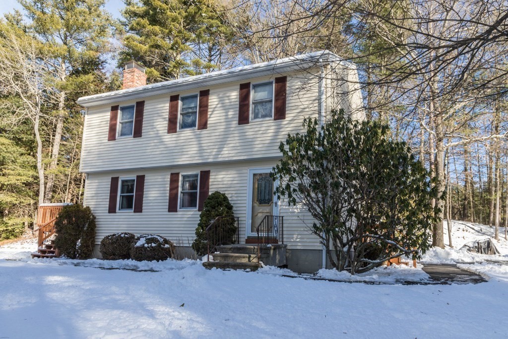 a view of a house with a yard and garage