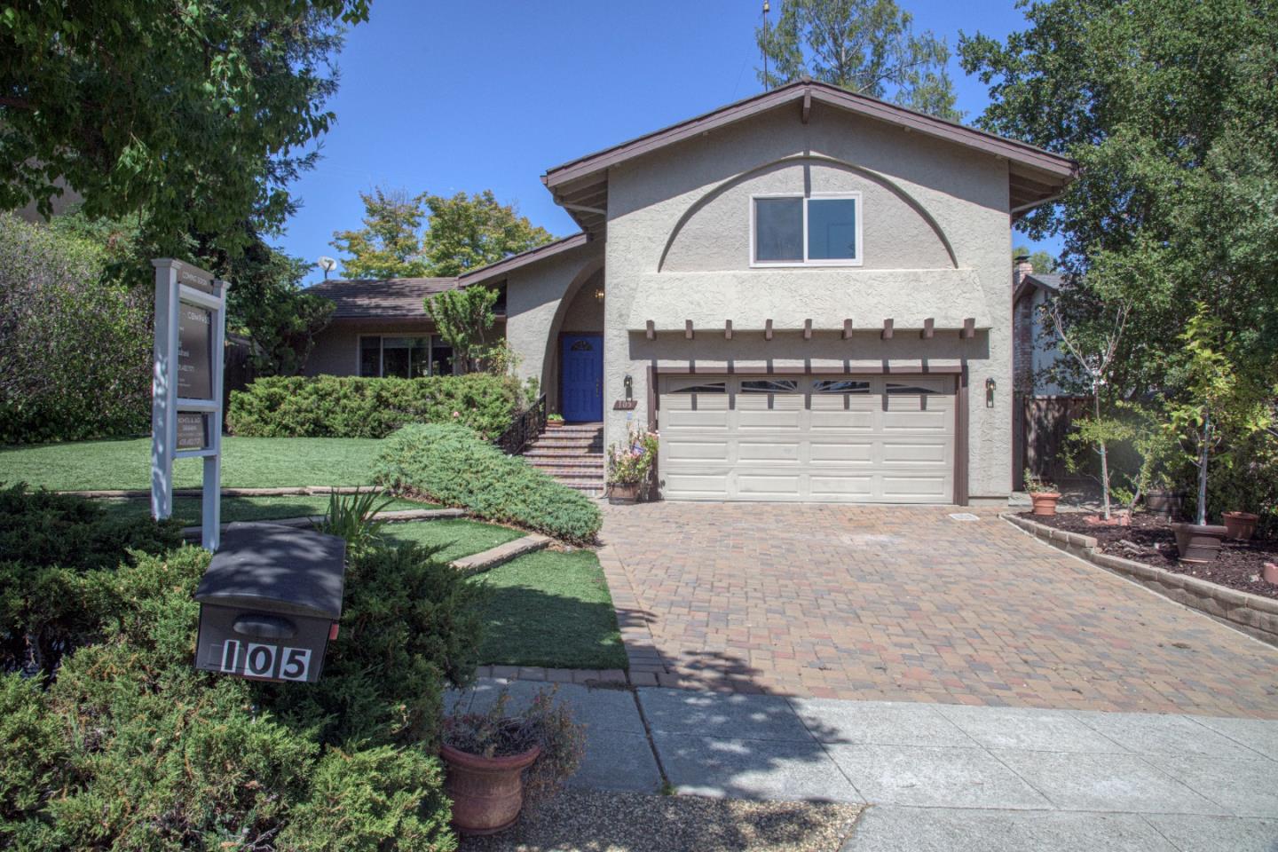 a view of a house with a yard and garage