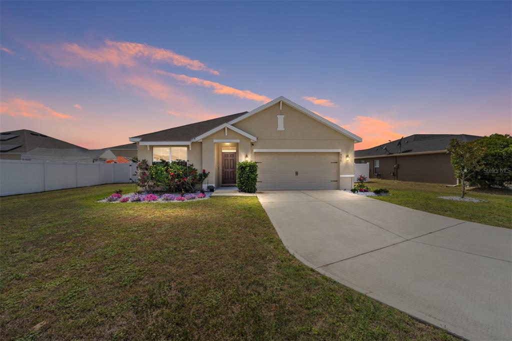 a front view of a house with a yard and garage