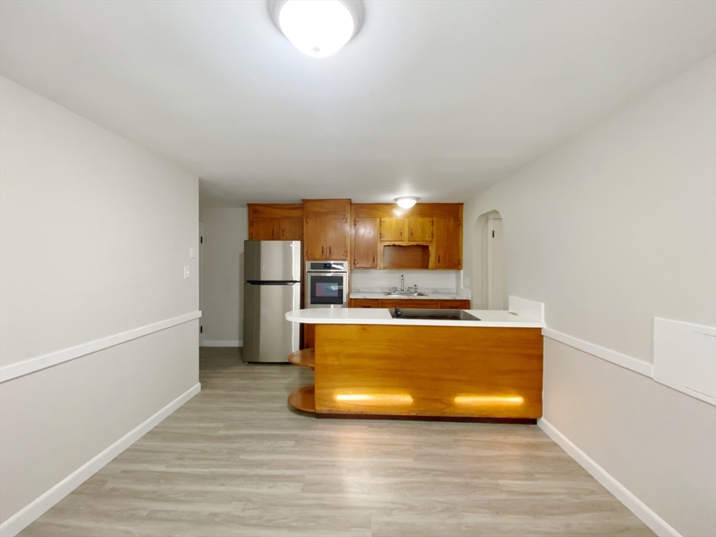 a view of kitchen with stainless steel appliances granite countertop a stove a refrigerator and a microwave