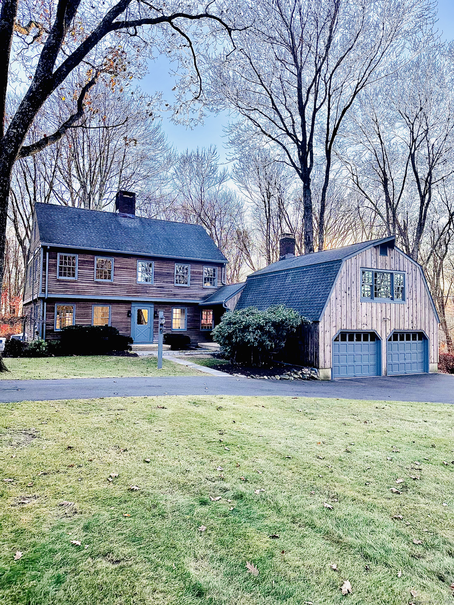 a house that has a big yard with large trees