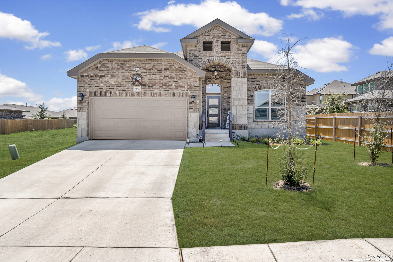 a front view of a house with a yard