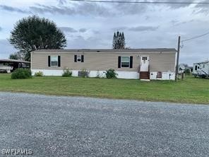 a front view of a house with a garden and yard