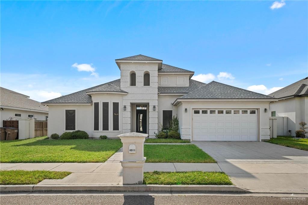 a front view of a house with a yard and garage