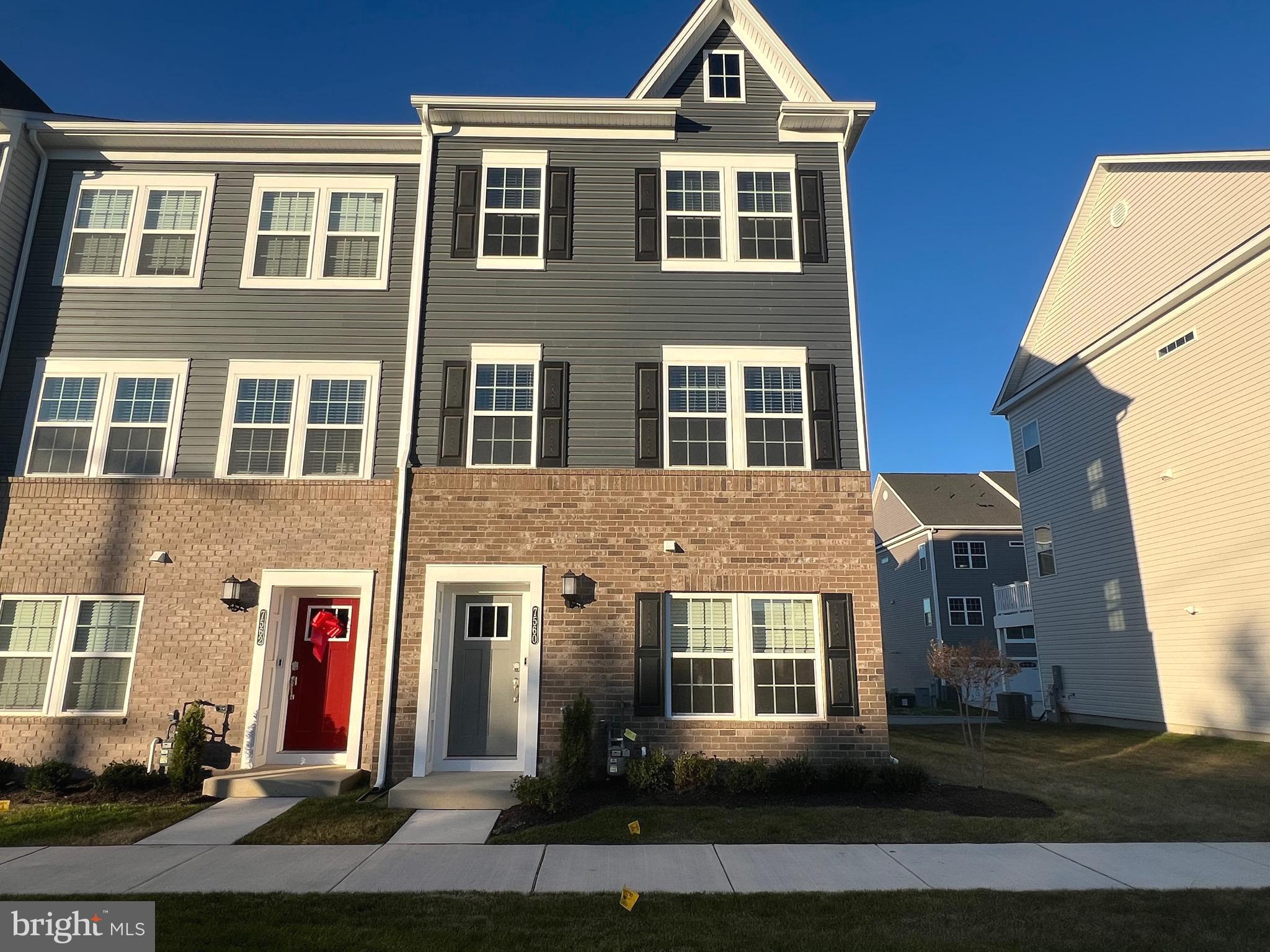 a front view of a residential apartment building with a yard