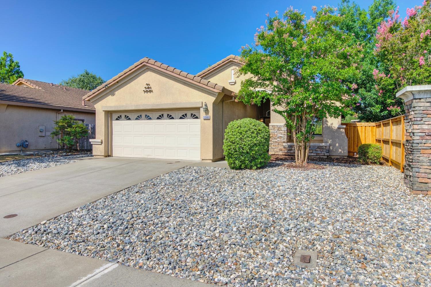 a view of a house with a yard and garage