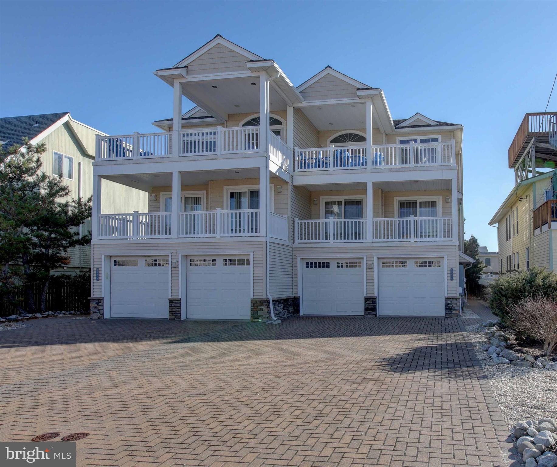 a front view of a building with a yard and parking space