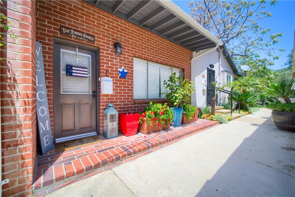 a view of a house with potted plants